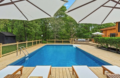 Hampton Bays House | Chic Hampton Bays escape with private heated pool, expansive sundeck, and.