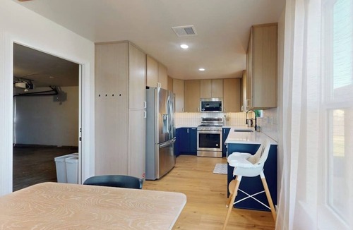 Scofield Farms House | Modern home with an enclosed backyard with wood fire pit in North Austin