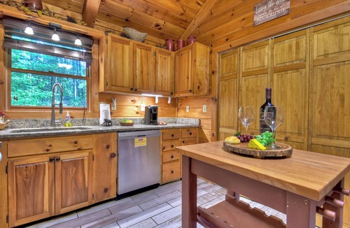 McCaysville Cabin | Nestled by the babbling creek, Creekside Hideaway warmly welcomes pets, offering a hot tub, over-sized screened porch with TV, firepit, and WiFi