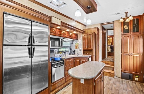 Milton RV Rental | THIS IS AN AWESOME 36' RENTAL CAMPER WITH AMAZING LONG DECK, PLUS A SECOND STEP-DOWN DECK TO YOUR OWN PRIVATE HIDEAWAY TIKI BAR! A BEAUTIFUL HUGE LIVE OAK COVERS THE ENTIRE LOT SO IT'S ALWAYS SHADED, AND THIS EVEN COMES WITH A TABLE & CHAIRS FOR OUT