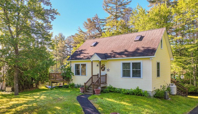 Lakefront home on Sheldrake Cove with dock & firepit