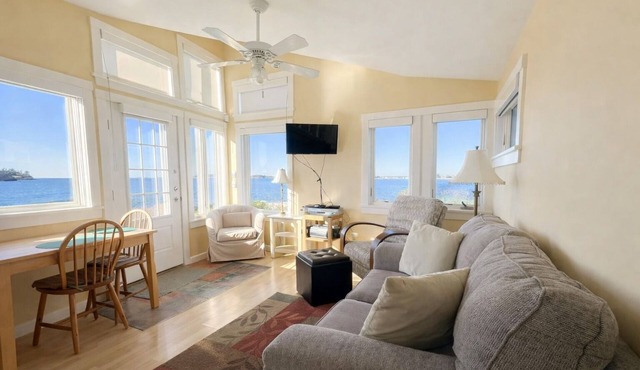 This sweet cottage offers a shared pebbly beachfront and gorgeous sunset views