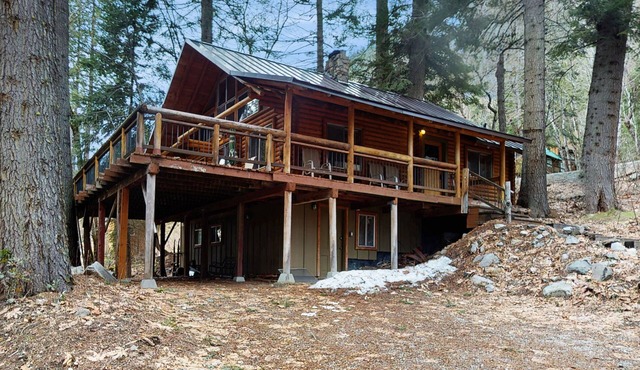 Two-story log home w/loft, lake views, wood stove, furnished deck + beach access
